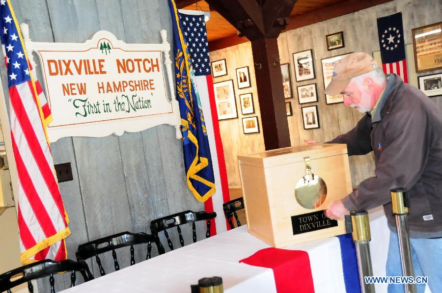 A working staff puts the ballot box on a table during the preparation for the voting at a polling station in Dixville Notch, New Hampshire, the United States, Nov. 5, 2012. Ten registered voters are expected to cast their ballots at the stroke of midnight on Tuesday Nov. 6, in Dixville Notch, signifying the official beginning of the voting in the 2012 U.S. presidential elections. (Xinhua/Zhang Chuanshi) 