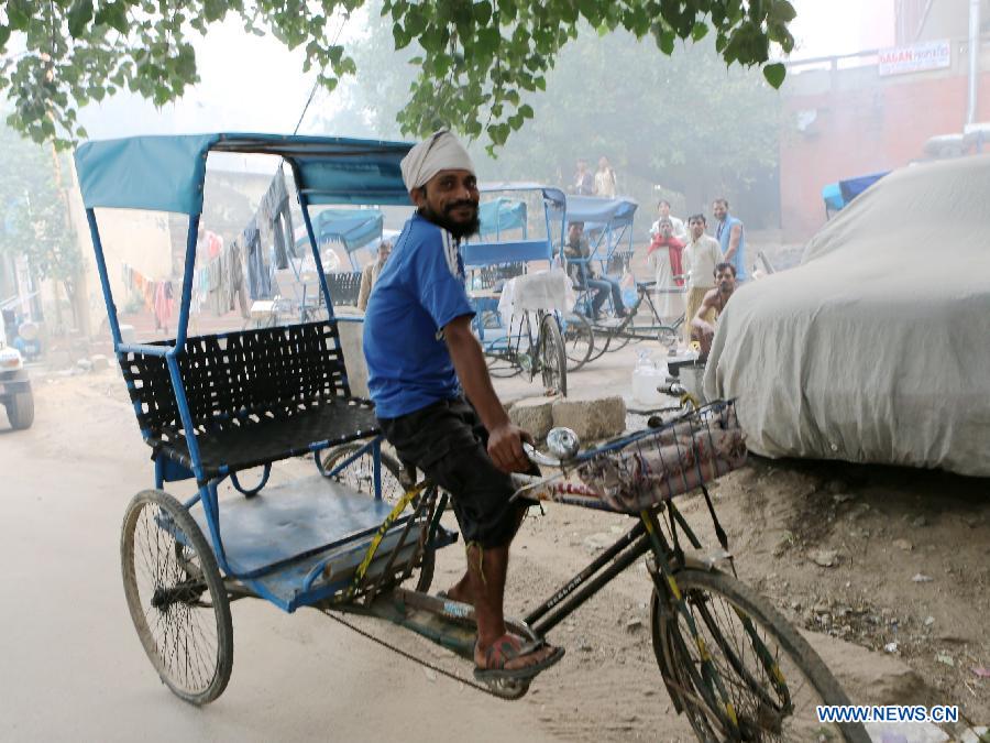 A rickshaw driver rests in East Patel Nagar, northern New Delhi, India, on Nov. 5, 2012. Rickshaw drivers' life is hard in the old city of New Delhi. (Xinhua/Li Yigang) 