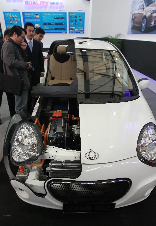 Visitors look at the interior of an electric car during the 14th China International Industry Fair in east China's Shanghai Municipality, Nov. 6, 2012. The industry fair opened to the public Tuesday at Shanghai New International Expo Center, with 1,648 exhibitors from at home and abroad. (Xinhua/Pei Xin) 