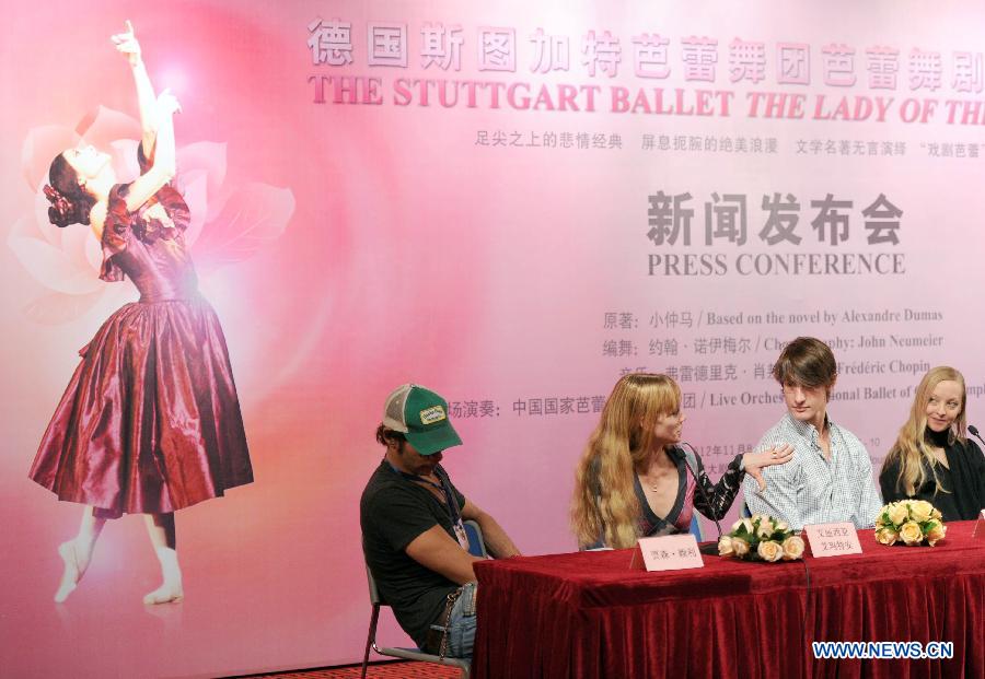 Several cast members communicate during a press conference of stage drama "The Lady of The Camallias" in Beijing, capital of China, Nov. 6, 2012. (Xinhua/Luo Xiaoguang)