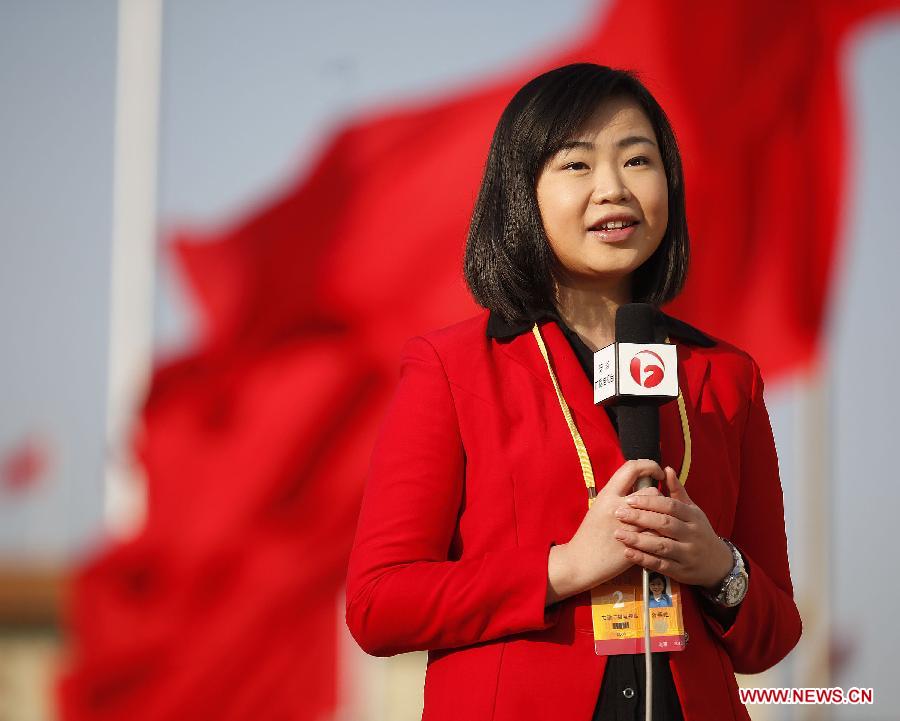 A news anchor from east China's Anhui Province conducts report at the Tian'anmen Square in Beijing, capital of China, Nov. 8, 2012. The 18th National Congress of the Communist Party of China (CPC) opened in Beijing on Thursday, which also marks the 12th Journalists' Day of China. A total of 2,732 Chinese and foreign journalists are involved in the coverage of the 18th CPC National Congress. (Xinhua/Wang Shen)