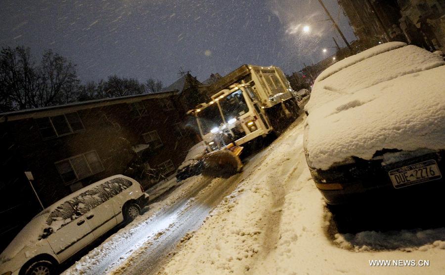 A snowplow works on the street at Queens in New York, the United States, Nov. 7, 2012. As New Jersey and New York are still trying to recover from the damage created by Hurricane Sandy, a Nor'easter named Winter Storm Athena dropped snow and rain on the Northeast on Wednesday, also bringing dangerous winds and knocking out power. (Xinhua/Wu Jingdan)