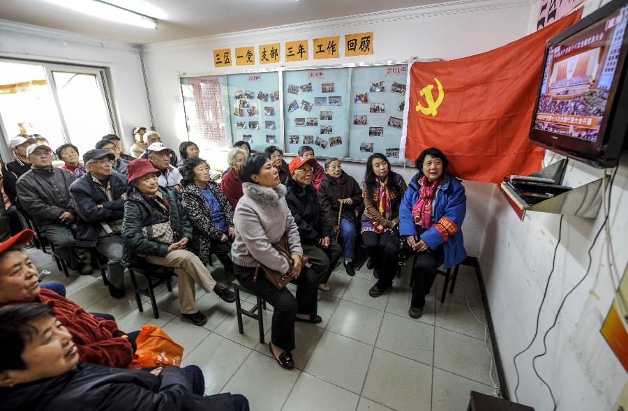 Members of the Communist Party of China (CPC) watch live TV report on the opening ceremony of the 18th CPC National Congress in Anzhenli residential community in Beijing, capital of China, Nov. 8, 2012. The 18th CPC National Congress was opened in Beijing on Thursday. (Xinhua/Zhang Yu)