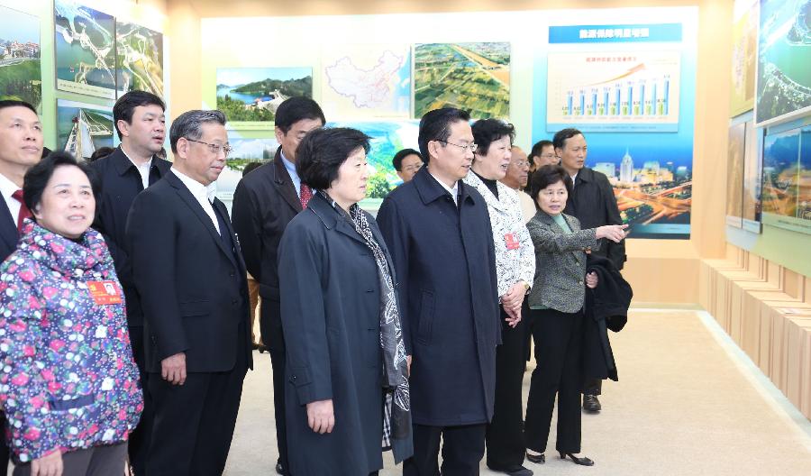 Delegates to the 18th National Congress of the Communist Party of China (CPC) visit a photo exhibition on achievements which China has gained under the leadership of the CPC, at Beijing Exhibition Center in Beijing, capital of China, Nov. 9, 2012. (Xinhua/Wang Jianmin)