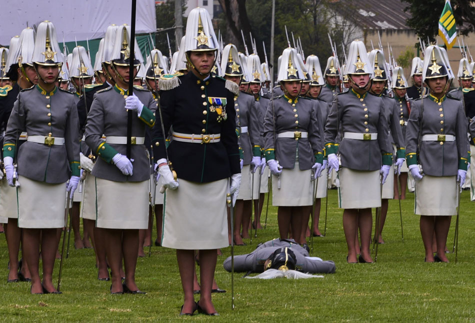 A policewoman lies on the ground after fainting during a ceremony marking the 121st anniversary of the National Police, in Bogota, Colombia, Nov. 2, 2012 (Xinhua/AFP)