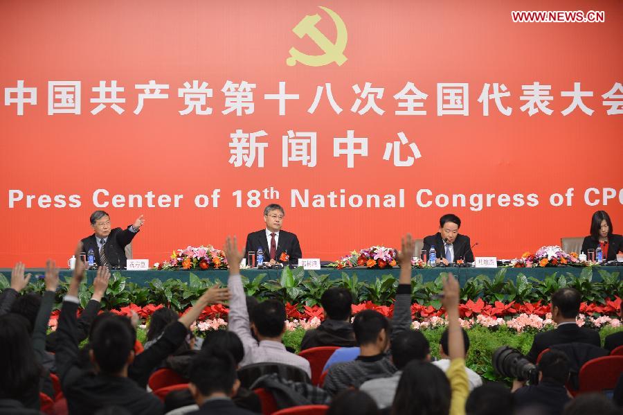 Guo Shuqing (2nd L), chairman of the China Securities Regulatory Commission, and Gui Minjie (2nd R), board chairman of the Shanghai Stock Exchange and the China Financial Futures Exchange, attend a group interview at the press center of the 18th National Congress of the Communist Party of China (CPC) in Beijing, capital of China, Nov. 11, 2012. (Xinhua/Li Xin)