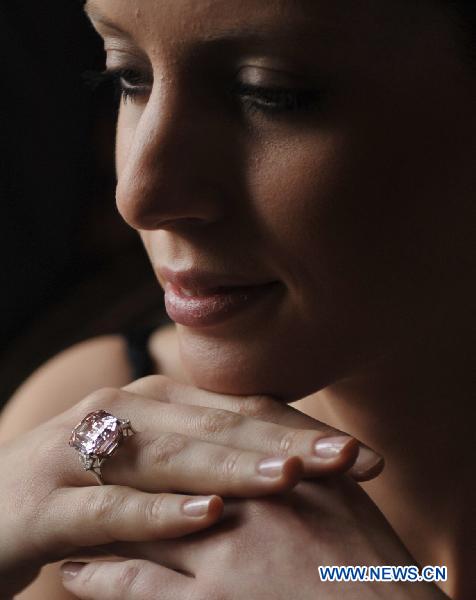 A model displays a 24.78-carat Fancy Intense Pink Diamond that will be on Sothebys' auction of Magnificent Jewels on Nov. 16, 2010 during a press preview held in Hotel Beau Rivage, Geneva, Switzerland, Nov. 10, 2010. (Xinhua/Yu Yang)