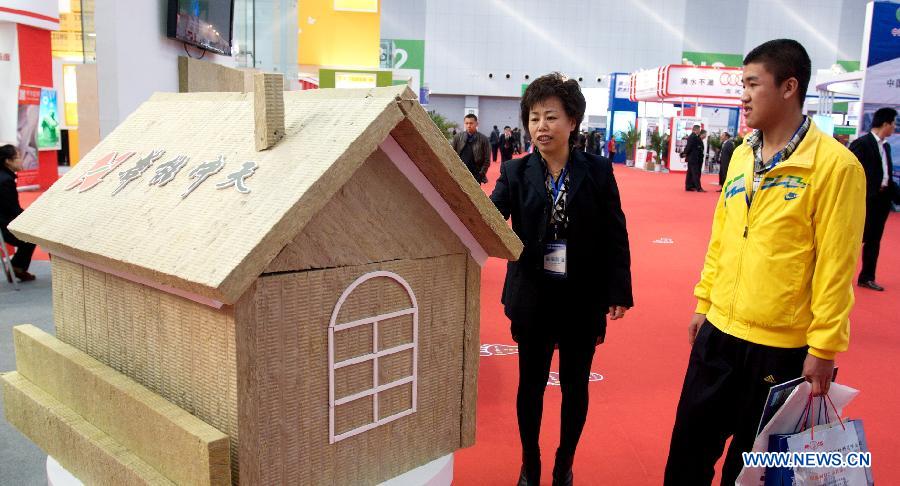 Visitors listen to the introduction of a latest rock wool at the "2012 International Building Materials and Decoration Fair" in north China's Tianjin Municipality, Nov. 9, 2012. The fair, with the participation of more than 800 enterprises, opened here on Friday. (Xinhua/Wang Qingyan)