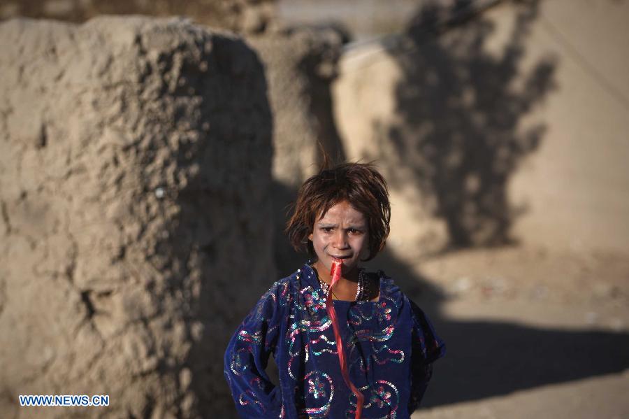 A displaced child stands outside a tent at a camp for displaced people in Kabul, Afghanistan, on Nov. 10, 2012. (Xinhua/Ahmad Massoud)