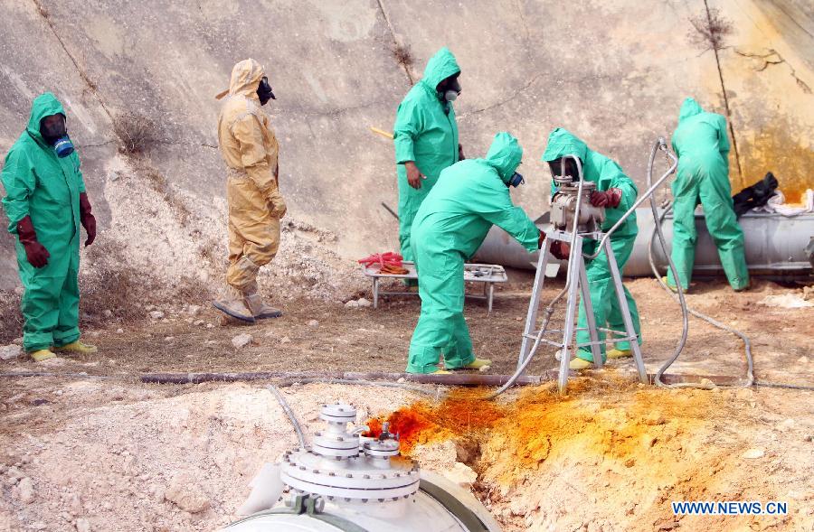 A team of Libyan experts and military engineers dismantles a rocket under the supervision of the United Nations, in Tripoli, Nov. 11, 2012. Experts were assigned to dump the toxic chemicals found in the air defense missiles and ammunition left over from the former Libyan leader Moamer Kadhafi's regime. (Xinhua/Hamza Turkia) 