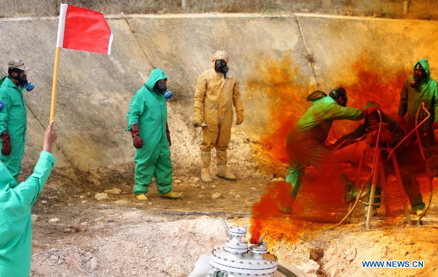 A team of Libyan experts and military engineers dismantles a rocket under the supervision of the United Nations, in Tripoli, Nov. 11, 2012. Experts were assigned to dump the toxic chemicals found in the air defense missiles and ammunition left over from the former Libyan leader Moamer Kadhafi's regime. (Xinhua/Hamza Turkia) 