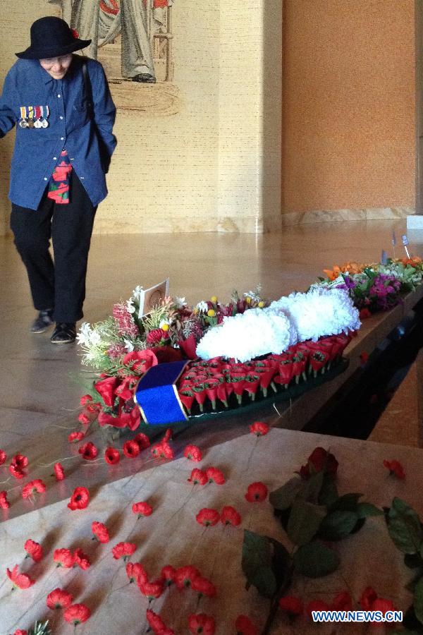 A woman wearing her father's medals from the World War I visits the War Memorial in Canberra, Australia, Nov. 11, 2012. Ceremonies marking the 11th hour of the 11th day of the 11th month, remember the moment in 1918 when the guns of the World War I fell silent. (Xinhua/Justin Qian)