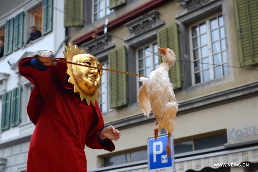 A contestant participates in the Gansabhauet in Sursee, Nov. 11, 2012. Gansabhauet (cutting down the goose from a rope) was held in the town of Sursee near Lucerne, central Switzerland on Sunday to celebrate the St. Martin's Day. (Xinhua/Wang Siwei)