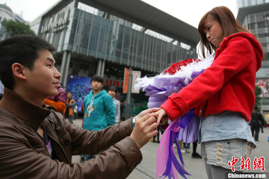 Qian, moved by the romantic actions of his boyfriend Ou Wenbin, accepts his proposal in Chongqing on Nov. 10 2012, just one day before Single's Day. Ou Wenbin, 25, organized 30 friends to dance "Gangnam Style" for Qian and spent one month's salary to rent a large screen at Silver Plaza in Yuzhong district to play the encouraging videos from more than 60 friends. (Chinanews.com)  