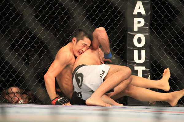 South Korean fighter Dong Hyun Kim works from the bottom in his fight against Paulo Thiago at UFC Macao, November 10, 2012. [Photo: CRIENGLISH.com/Xu Weiyi] 