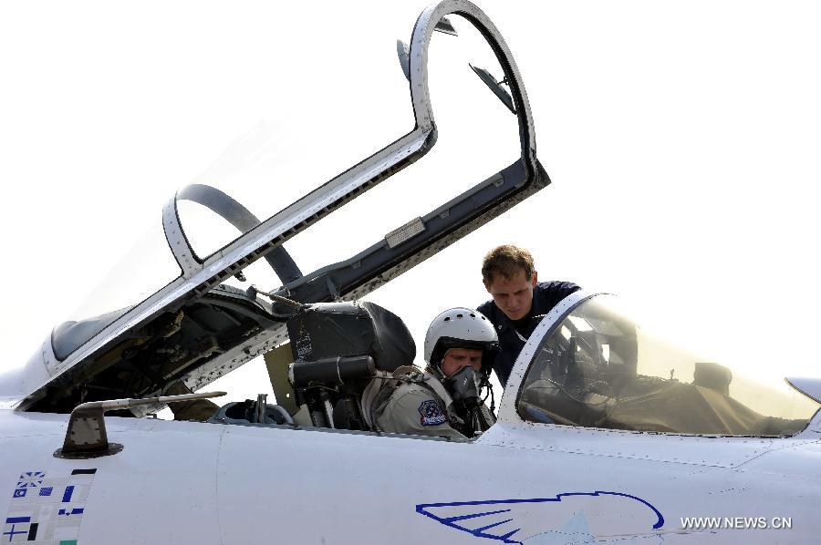 A pilot of Russian aerobatic tam "Russian Knights" prepares for a test flight in Zhuhai, south China's Guangdong Province, Nov. 12, 2012. The 9th China International Aviation and Aerospace Exhibition will kick off on Tuesday in Zhuhai. (Xinhua/Liang Xu) 