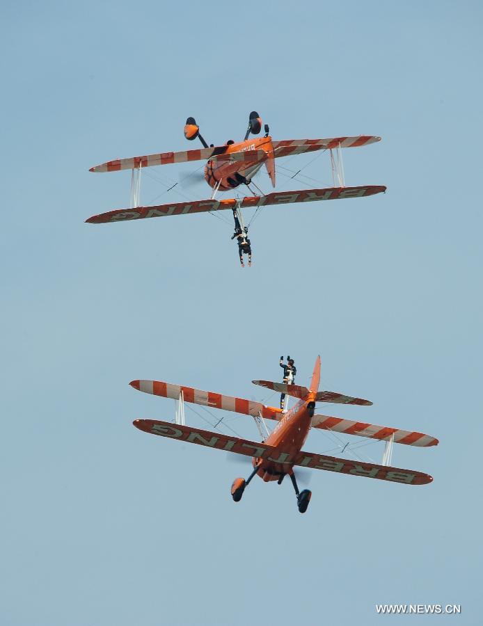 Members of Breitling Wingwalkers, a famous European aerobatic team, perform during a test flight in Zhuhai, south China's Guangdong Province, Nov. 11, 2012. The 9th China International Aviation and Aerospace Exhibition will kick off on Tuesday in Zhuhai. Breitling Wingwalkers is known for its acrobats who perform on the wings of Boeing Stearman biplanes in mid-air. (Xinhua/Yang Guang) 