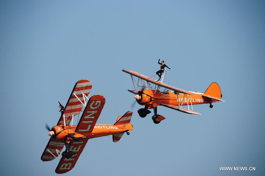 Members of Breitling Wingwalkers, a famous European aerobatic team, perform during a test flight in Zhuhai, south China's Guangdong Province, Nov. 11, 2012. The 9th China International Aviation and Aerospace Exhibition will kick off on Tuesday in Zhuhai. Breitling Wingwalkers is known for its acrobats who perform on the wings of Boeing Stearman biplanes in mid-air. (Xinhua/Yang Guang) 