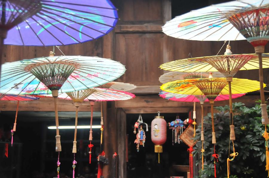 Photo taken on Nov. 12, 2012 shows oil-paper umbrellas at a workshop in Xixiu District of Anshun City, southwest China's Guizhou Province. Made of oiled paper and bamboo frame, oil-paper umbrella is a traditional Chinese handicraft. The skills of making oil-paper umbrellas were introduced to Guizhou in early Ming Dynasty (1368-1644). (Xinhua/Huang Yong) 