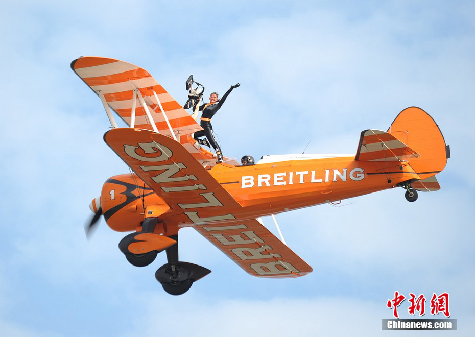 Photo taken on Nov. 11, 2012 shows the wingwalkers of Beritling Jet Tem, a famous European aerobatic team, putting on wonderful performance on the wings of biplaines during a test flight for the Airshow China 2012. The airshow kicked off on Tuesday morning in south China’s Zhuhai. (Photo/Chinanews.com)