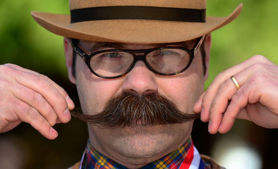 A contestant poses after winning first place in the Freestyle Moustache category at the third annual National Beard and Moustache Championships in Las Vegas, Nevada on November 11, 2012. (Xinhua/AFP)