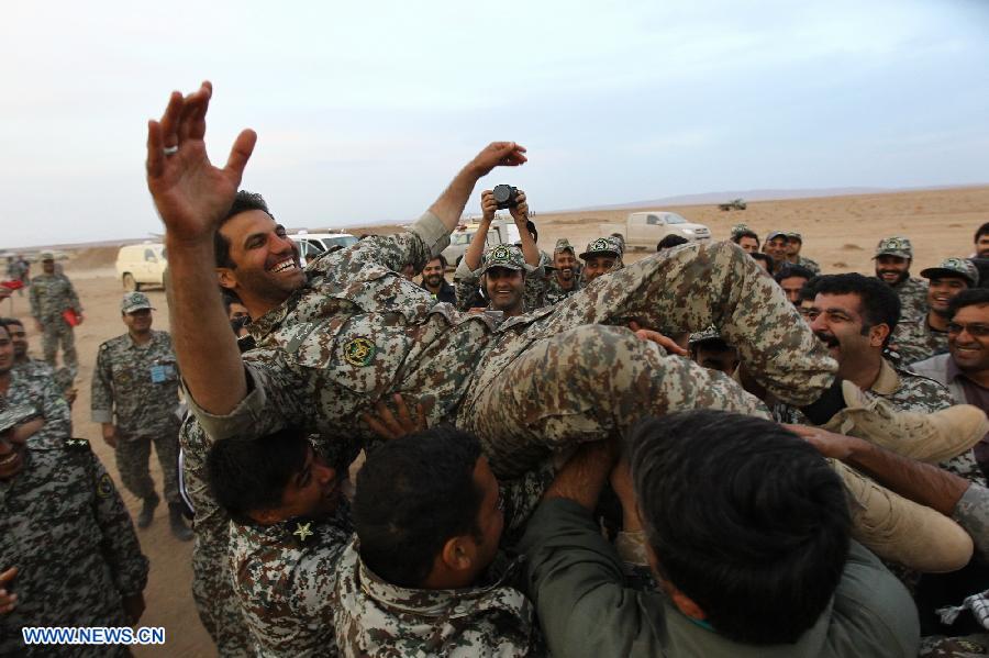 Iranian army personnel celebrate after successfully launching a surface-to-air missile during military maneuvers at an undisclosed location in Iran on Nov. 13, 2012. (Xinhua)