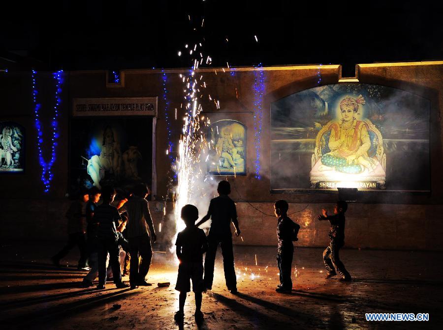 Pakistani Hindu children play with fireworks to celebrate the Hindu festival of Diwali, in southern Pakistani port city of Karachi, on Nov. 13, 2012. People light lamps and offer prayers to the goddess of wealth Lakshmi in the Hindu festival of Diwali, the festival of lights, which falls on Nov. 13 this year. (Xinhua/Masroor)