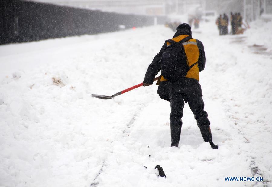 A working staff cleans snow piled aside tracks at the Hegang Railway Station in Hegang, northeast China's Heilongjiang Province, Nov. 13, 2012. Heavy snowstorms swept northeastern regions of Heilongjiang since last Sunday, forcing highways to close. Local authority of railway service initiated an emergency plan to maintain order of stranded passengers. (Xinhua/Wang Kai) 