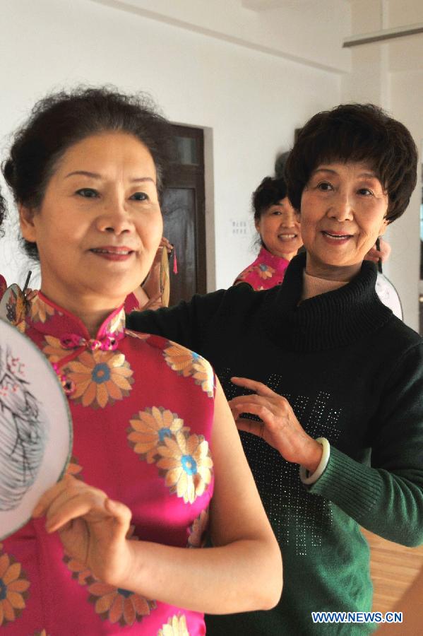 72-year-old Li Ling (R), leader of an elder model team, instructs her teammates' performance in Lanzhou, capital of northwest China's Gansu Province, Nov. 14, 2012. The elder model team that has 26 models with an average age of 62 is preparing for Gansu's 6th Elder Model Pageant that is to be held on Saturday. (Xinhua/Chen Bin)