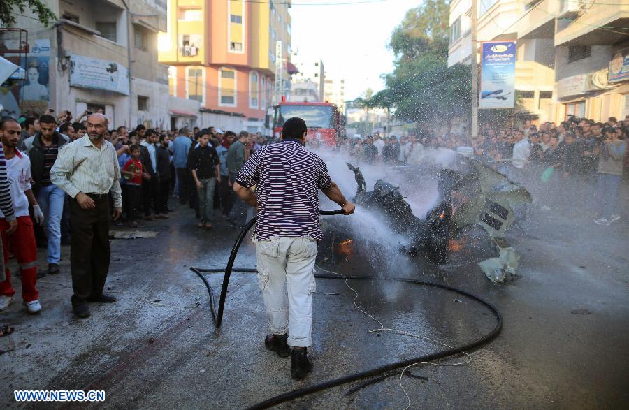 Emergency services extinguish the burned out car of Qassam top leader Ahmed Jabari after an Israeli air strike in Gaza City, Nov. 14, 2012. Hamas says the head of its military wing Ahmed al-Jaabari has been killed in an Israeli air strike. Israel said it had targeted Ahmed al-Jaabari because of what it called his terrorist activity. Seven Palestinians were killed following a series of Israel's airstrikes on Gaza city, and more than 40 others wounded, government's emergency services in the Gaza Strip said. (Xinhua/Wissam Nassar)