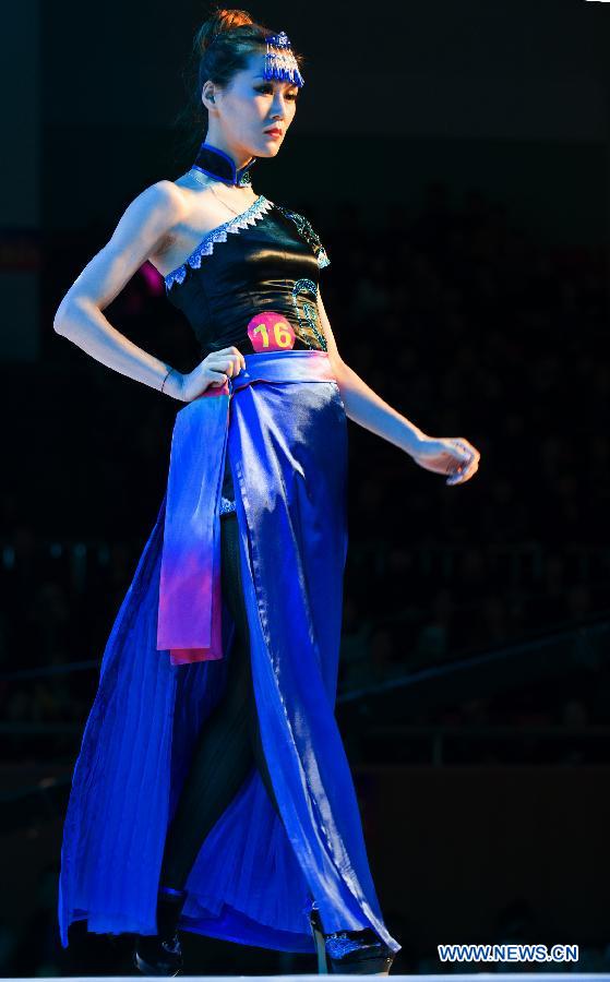 A model presents a creation during the 2012 She Ethnic Group Dress Design Competition in Jingning She Autonomous County, east China's Zhejiang Province, Nov. 17, 2012. The competition, with the aim to exploit the folk custom and ethnic costume of She Ethnic Group, attracted many contestants. (Xinhua/Li Suren) 