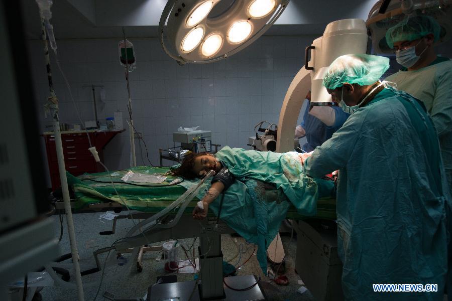 A wounded Palestinian girl receives treatment in al-aqsa hospital after an Israeli air strike in the Central Gaza Strip, on Nov. 18, 2012. Three Palestinian children were killed in Israeli air strikes on Sunday, hospital officials said. Israel bombed militant targets in Gaza for the fifth straight day on Sunday, launching aerial and naval attacks as its military prepared for a possible ground invasion. (Xinhua/Chen Xu) 