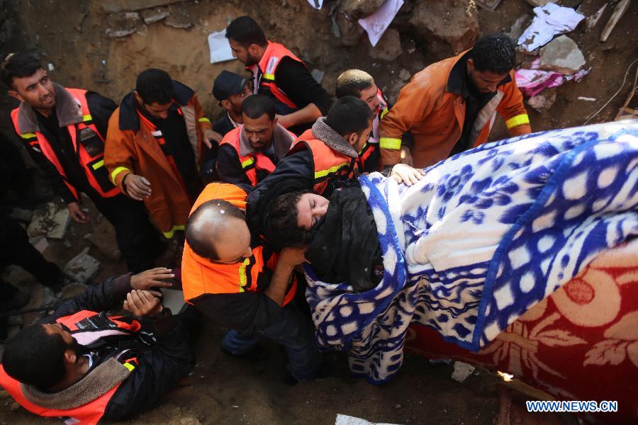 Palestinian civil defense staff members carry a survivor on a stretcher after she was pulled out from the rubble of a destroyed house after an Israeli airstrike on Gaza City, on Nov. 18, 2012. (Xinhua/Wissam Nassar)