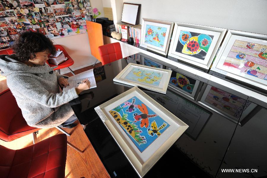 Paintings created by autistic children are seen in Huijia Chuangyi Restaurant in Xiaodian District of Taiyuan City, capital of north China's Shanxi Province, Nov.19, 2012. The restaurant has provided a platform to sell paintings by autistic children from Fangzhou Autism Rehabilitation Center in Shanxi since October in 2011. (Xinhua/Zhan Yan) 