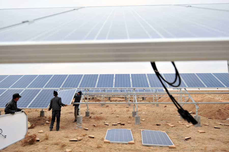 Workers install solar photovoltaic components in Minqin county, northwestern China's Gansu province on Nov. 19. (Xinhua/Liang Qiang)