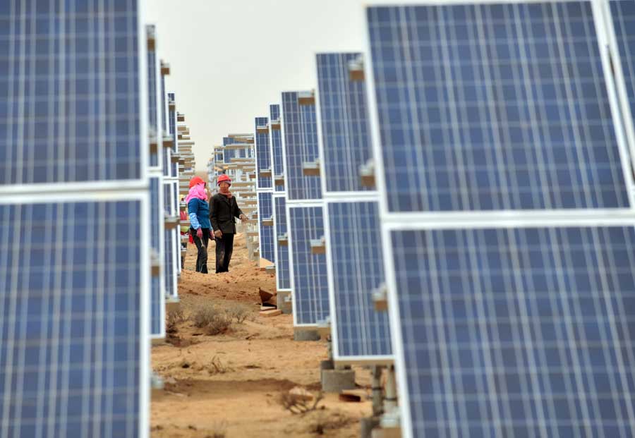 Workers install solar photovoltaic components in Minqin county, northwestern China's Gansu province on Nov. 19. (Xinhua/Liang Qiang)