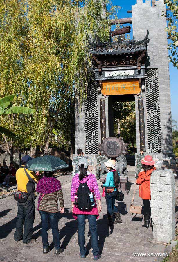 People visit the wetland park at the Qionghai Lake in Xichang City, southwest China's Sichuan Province, Nov. 20, 2012. The Qionghai wetland park attracted many visitors this winter. (Xinhua/Liu Chan) 