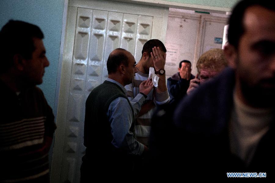 Palestinians react after they checked the body of their family member killed in an Israeli air strike, at Al-Adwan Hospital in Gaza City, Nov. 20, 2012. Hamas-run Ministry of Health said the death toll since Wednesday in the Gaza Strip has climbed to 130 and more than 1,000 people were wounded in the ongoing Israeli aerial operation on the coastal enclave. (Xinhua/Chen Xu) 