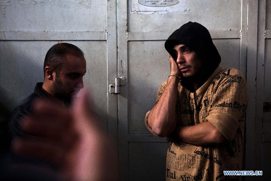 Palestinians react after they checked the body of their family member killed in an Israeli air strike, at Al-Adwan Hospital in Gaza City, Nov. 20, 2012. Hamas-run Ministry of Health said the death toll since Wednesday in the Gaza Strip has climbed to 130 and more than 1,000 people were wounded in the ongoing Israeli aerial operation on the coastal enclave. (Xinhua/Chen Xu) 