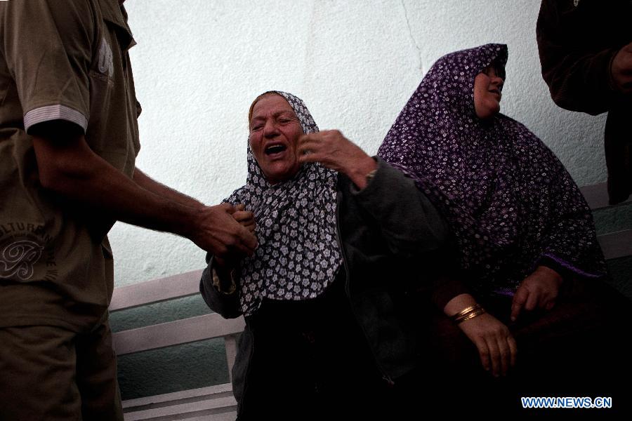 Palestinians react after they checked the body of their family member killed in an Israeli air strike, at Al-Adwan Hospital in Gaza City, Nov. 20, 2012. Hamas-run Ministry of Health said the death toll since Wednesday in the Gaza Strip has climbed to 130 and more than 1,000 people were wounded in the ongoing Israeli aerial operation on the coastal enclave. (Xinhua/Chen Xu) 