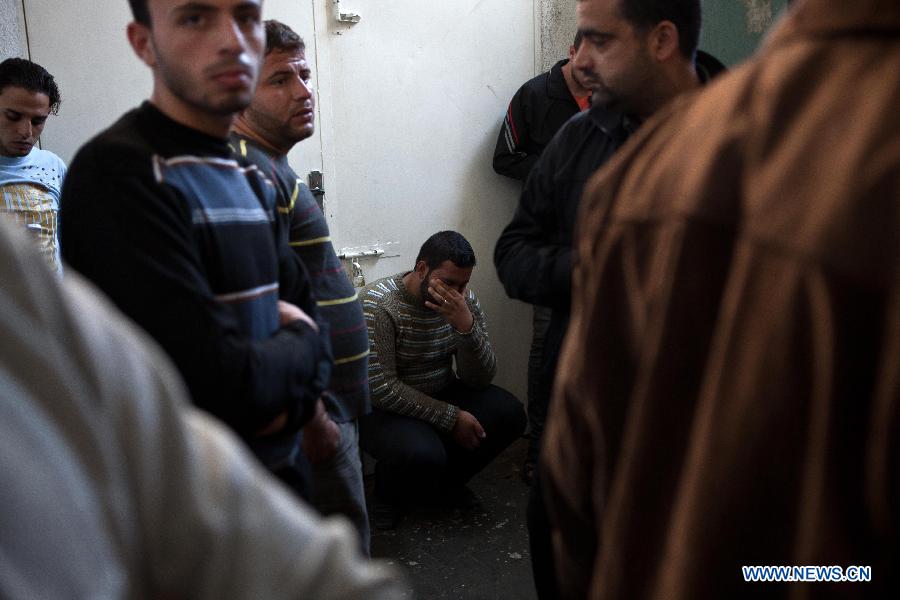 Palestinians react after they checked the body of their family member killed in an Israeli air strike, at Al-Adwan Hospital in Gaza City, Nov. 20, 2012. Hamas-run Ministry of Health said the death toll since Wednesday in the Gaza Strip has climbed to 130 and more than 1,000 people were wounded in the ongoing Israeli aerial operation on the coastal enclave. (Xinhua/Chen Xu) 