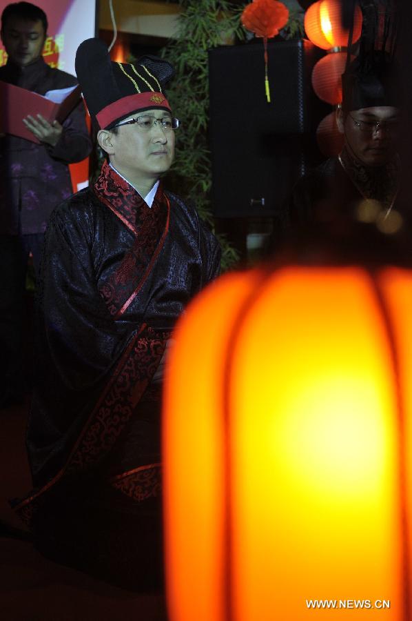 Peng Yong, the groom, attends a traditional Chinese wedding in Guiyang, capital of southwest China's Guizhou Province, Nov. 19, 2012. The traditional Chinese wedding, pursuant to the etiquettes of the Zhou Dynasties (1046-256BC), sees a resurgence in recent years as the sense of identity grows among modern Chinese couples. (Xinhua/Ou Dongqu) 