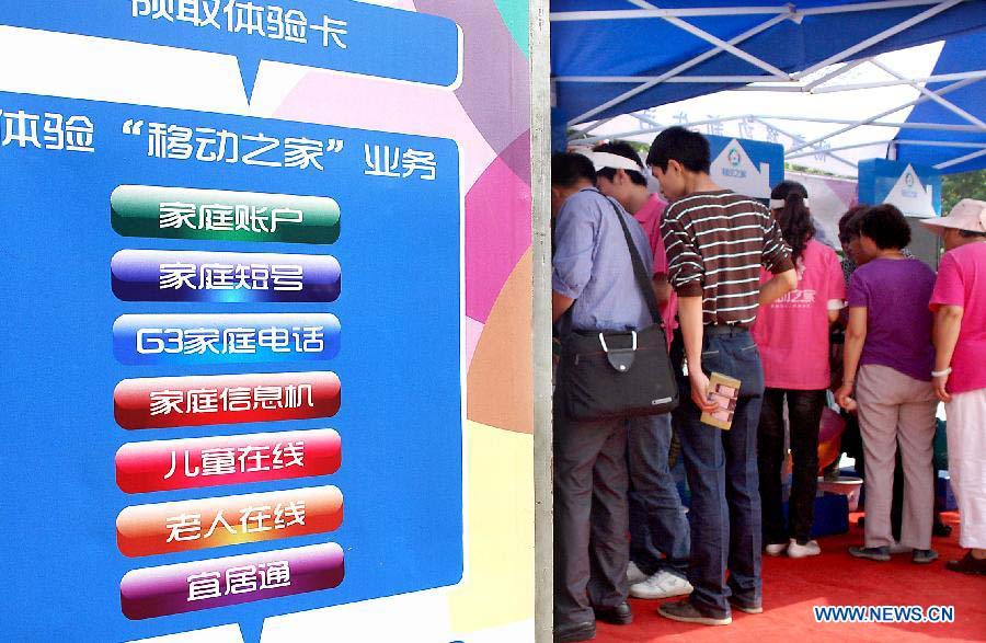 File photo taken on May 17, 2011 shows that visitors consult a telecommunication operator about information in an activity themed on "World Telecommunications Day" in Zhengzhou, capital of central China's Henan Province. (Xinhua/Wang Song)