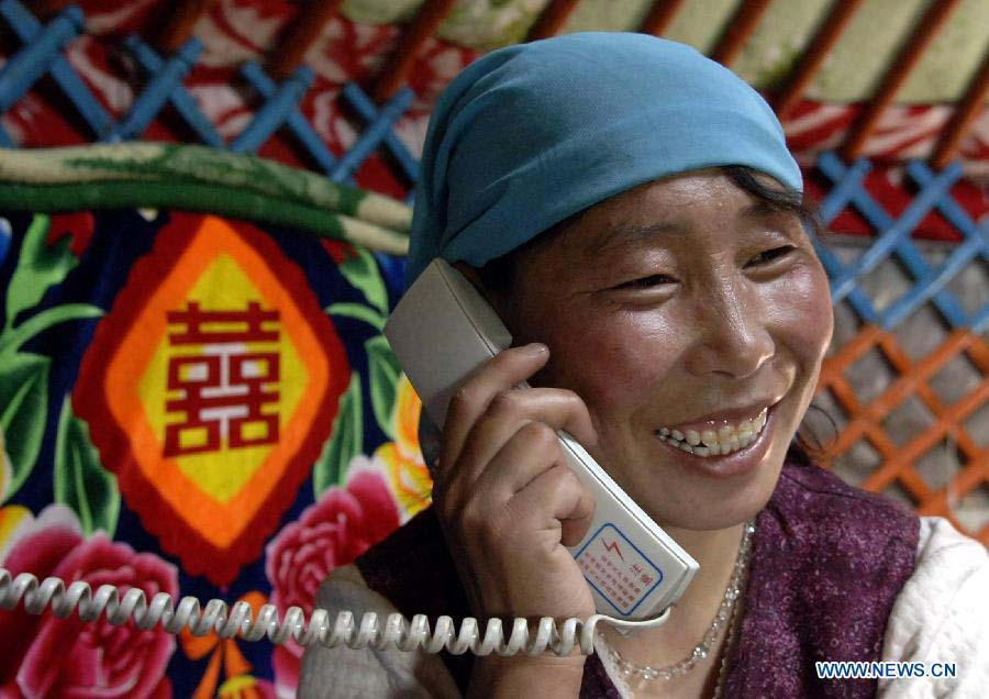 File photo taken on May 22, 2007 shows that a female herder talks with friends by a program-controlled telephone in a Mongolian yurt in Hexigten Qi, north China's Inner Mongolia Autonomous Region. (Xinhua/Wang Song)