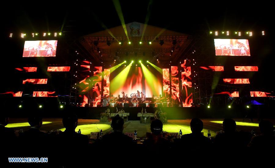 People watch the opening ceremony of the first China Puer International Country Music Festival in Puer, southwest China's Yunnan Province, Nov. 20, 2012. The festival kicked off on Tuesday with the participation of more than 20 bands and singers. The new silk road Miss World contest will also be held along with the festival. (Xinhua/Li Mingfang) 