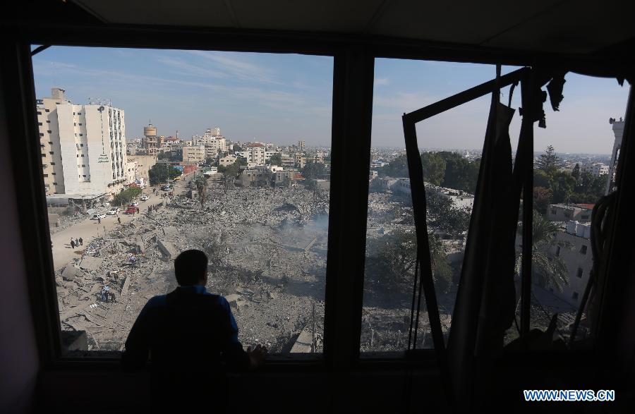 A Palestinian man inspects the destroyed compound of the internal security ministry in Gaza City after it was targeted by an overnight Israeli air strike on Nov. 21, 2012. (Xinhua/Wissam Nassar) 