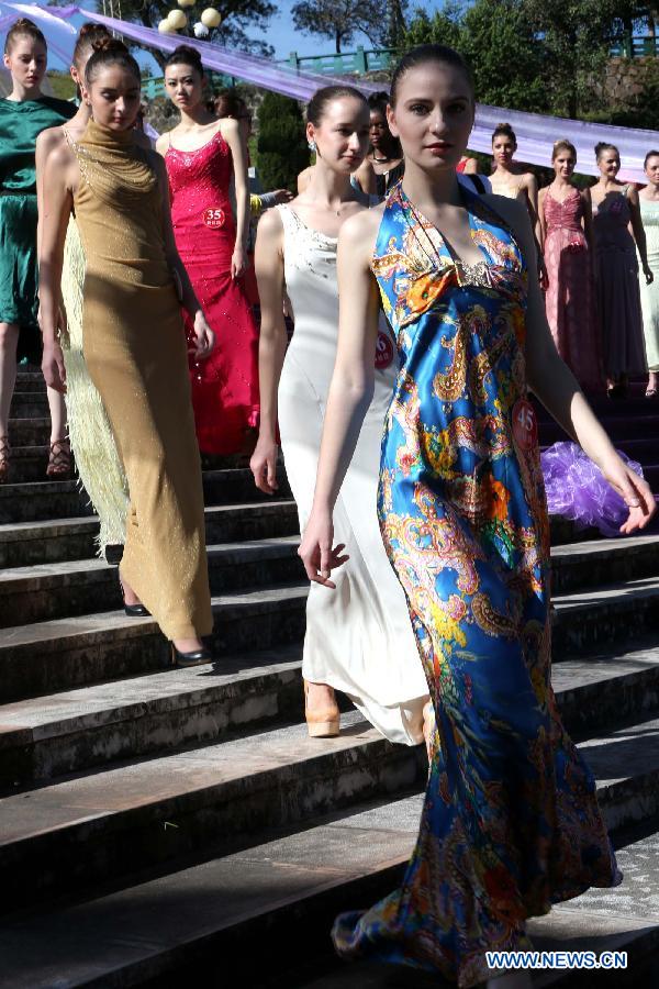 Contestants for the final of New Silk Road Miss World Competition rehearse at the Meizihu Garden in Pu'er, southwest China's Yunnan Province, Nov. 22, 2012. The contestants will also attend joint performance with country music bands at the 1st Pu'er International Country Music Festival. (Xinhua/Li Mingfang)