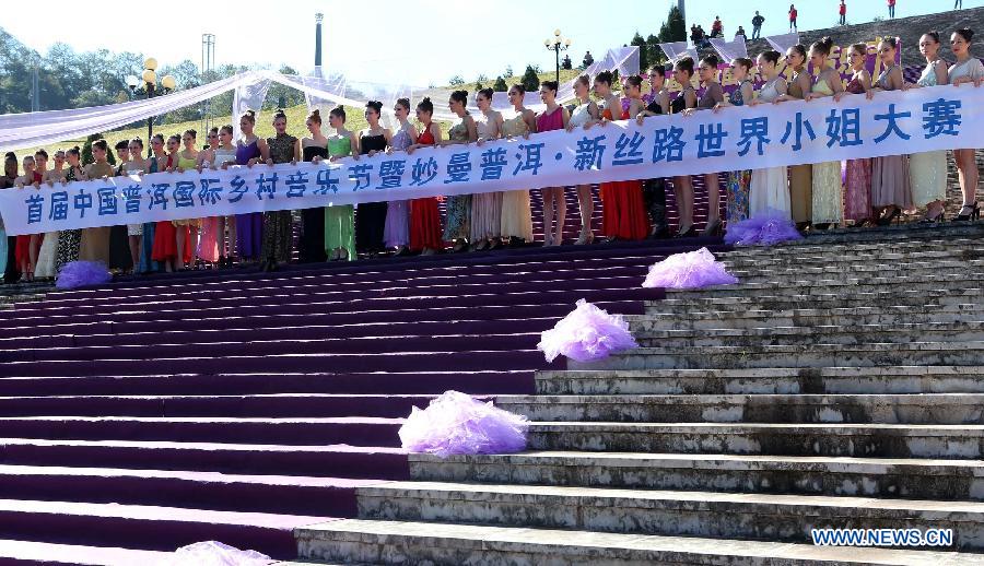 Contestants for the final of New Silk Road Miss World Competition pose for group photo at the Meizihu Garden in Pu'er, southwest China's Yunnan Province, Nov. 22, 2012. The contestants will also attend joint performance with country music bands at the 1st Pu'er International Country Music Festival. (Xinhua/Li Mingfang)