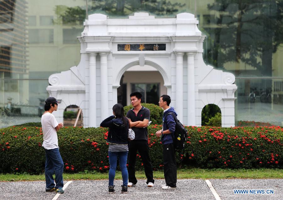 Students have a talk in front of a smaller school gate at the Tsing Hua University of southeast China's Taiwan in Hsinchu of Taiwan, Nov. 21, 2012. Since its establishment in 1956 in Hsinchu, Taiwan's Tsing Hua University has developed from an institute focusing on nuclear science to that of a comprehensive research university. The university shares the same motto, school song and school badge with Tsinghua University in Beijing, capital of China. (Xinhua/Xing Guangli) 