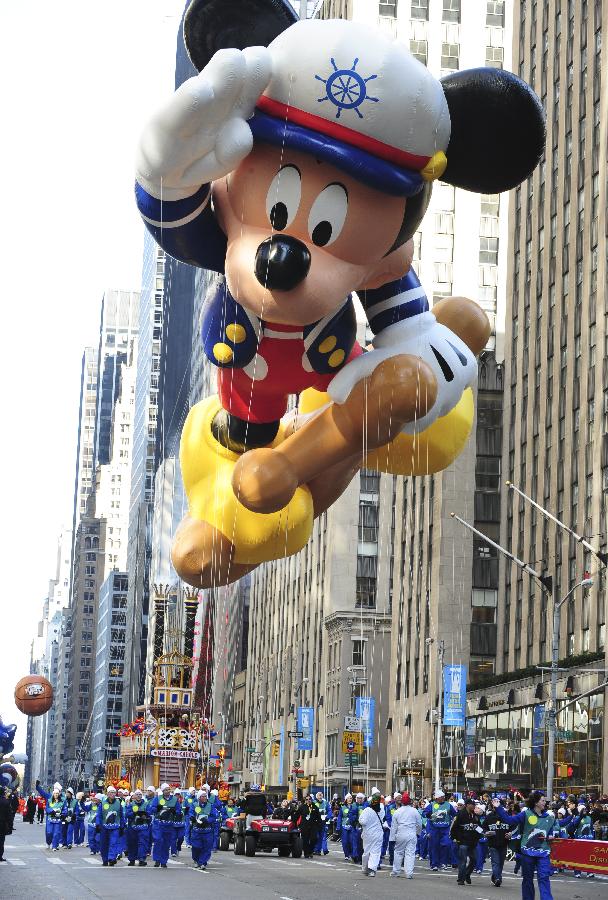 The Mickey Mouse balloon floats in the 86th Macy's Thanksgiving Day Parade in New York, the United States, Nov. 22, 2012. More than three million people gather along the street on Thursday, to attend the annual Macy's parade which began in 1924. (Xinhua/Deng Jian)